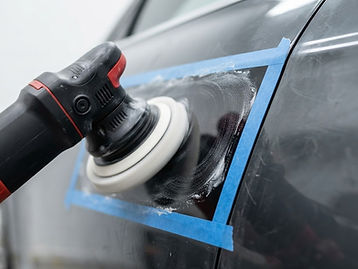 Machine polishing a section of car paint during paint correction