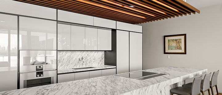 A residence kitchen: marble island, integrated cabinetry, and a wood-slat ceiling.