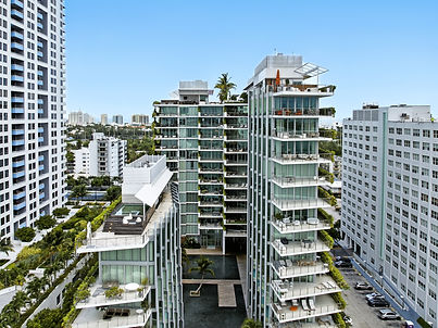 Two glass volumes around the central lagoon, with climbing gardens rising through the facades.