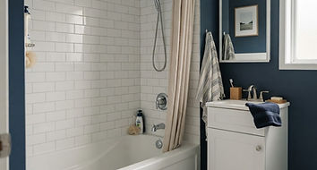 bathroom with a bathtub, shower fittings and a vanity faucet
