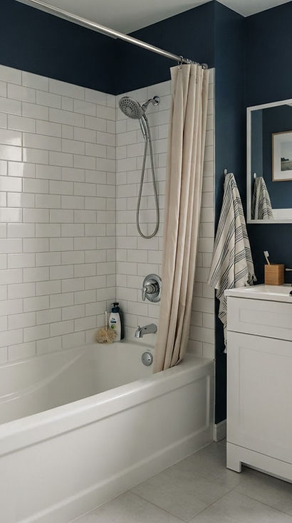 bathroom with a bathtub, shower fittings and a vanity faucet