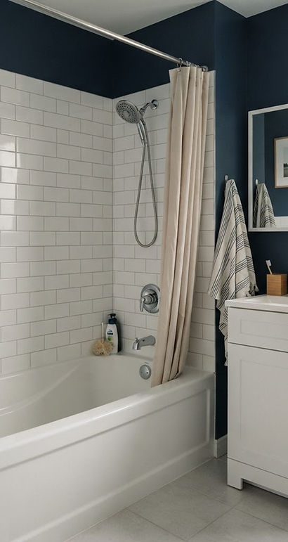 bathroom with a bathtub, shower fittings and a vanity faucet