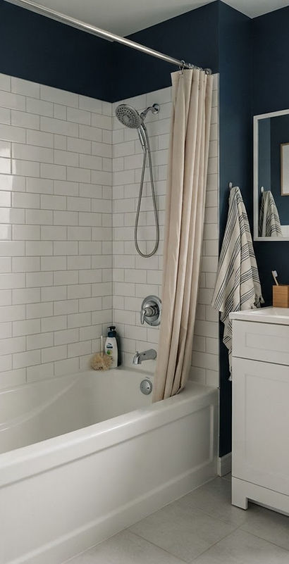 bathroom with a bathtub, shower fittings and a vanity faucet