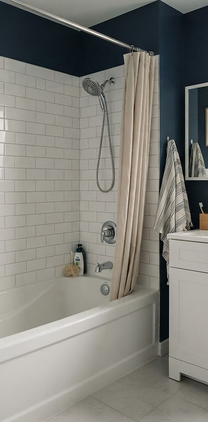 bathroom with a bathtub, shower fittings and a vanity faucet
