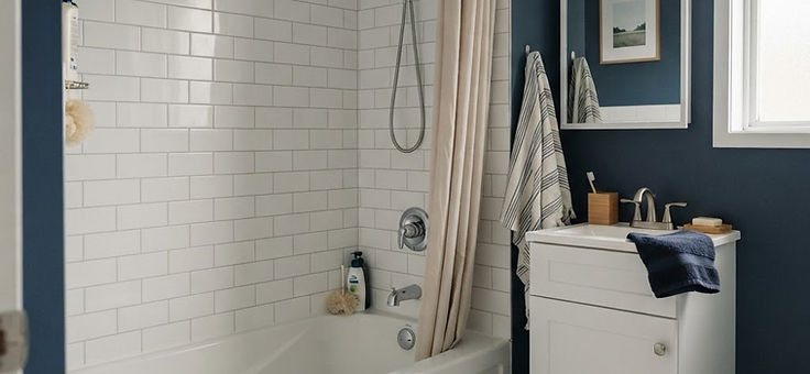 bathroom with a bathtub, shower fittings and a vanity faucet