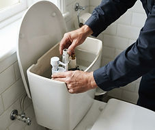 Plumbing work on a toilet cistern and its connections