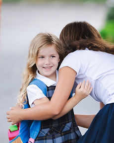 Two GCA students sharing a hug at drop-off