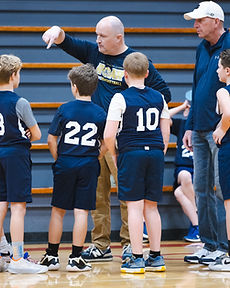 GCA coaches giving instructions to the Lions basketball team