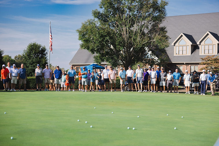 Golfers gathered around the green for the ball toss contest