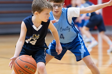 A GCA Lions player dribbling in a basketball game