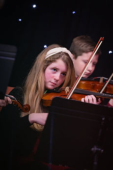 A GCA student playing violin in a concert