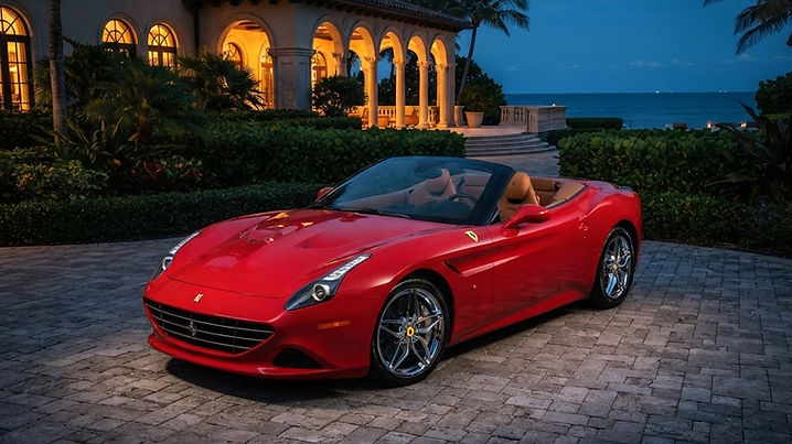 A red Ferrari California convertible parked at dusk outside an upscale Palm Beach waterfront mansion