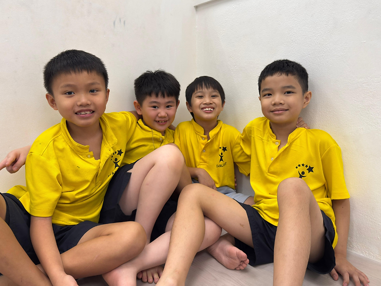 Starlight Centre students smiling together in their yellow uniforms