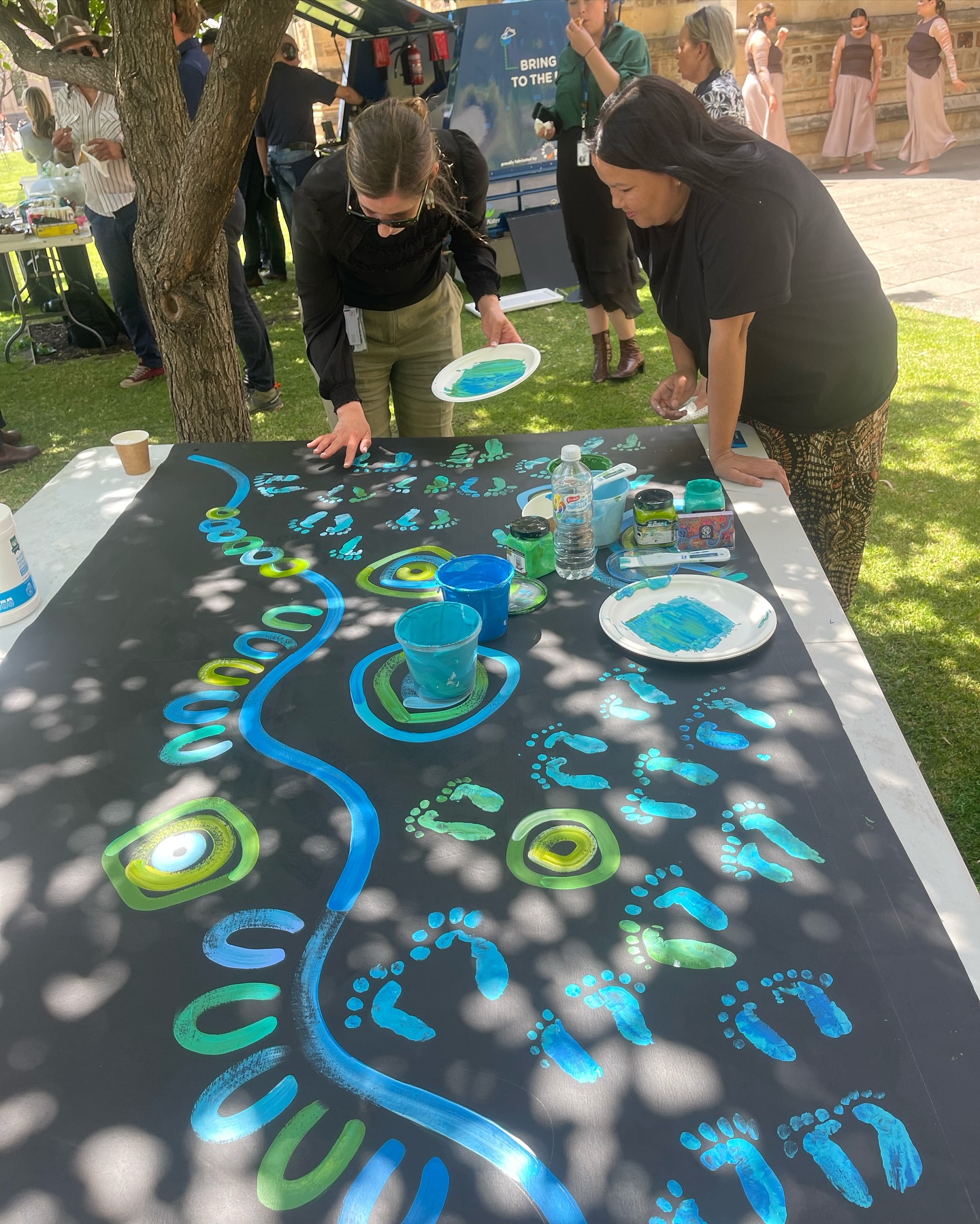 The reconciliation gathering — 100+ staff place their footprints