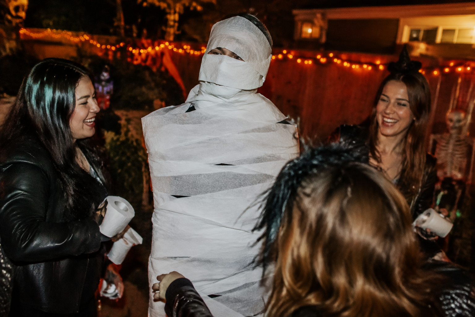 22. Mummy Wrap Game Zone - backyard Halloween party idea