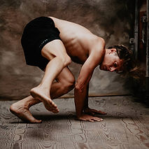 Primal Yoga natural movement practice, Sebastiaan Gamelkoorn performing an animal-flow exercise on a wooden studio floor, demonstrating primal yoga movement training in the Netherlands (primal-yoga-animal-movement.jpg)