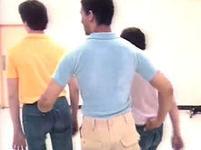 A line of three clients walking, each gripping the belt loop of the one ahead