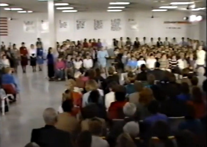 An open meeting at the Springfield warehouse, filmed from the back of the room