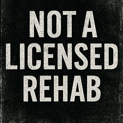 A placard reading Not a licensed rehab, lettered as if stencilled on newsprint