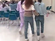 Three clients walking away across the room, the middle one held by the belt loop