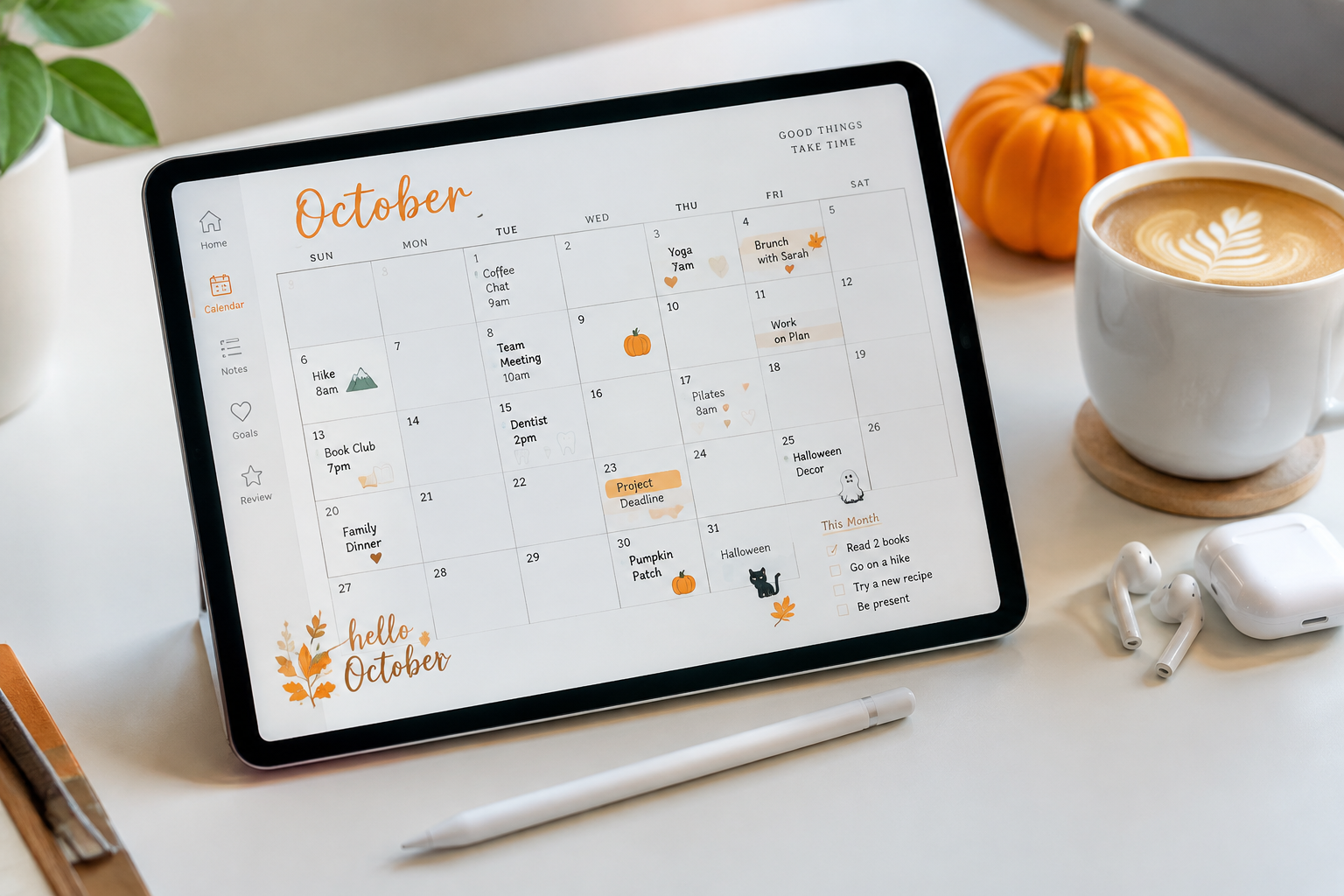 Digital October planner displayed on an iPad with a stylus, coffee and a small pumpkin on a white desk