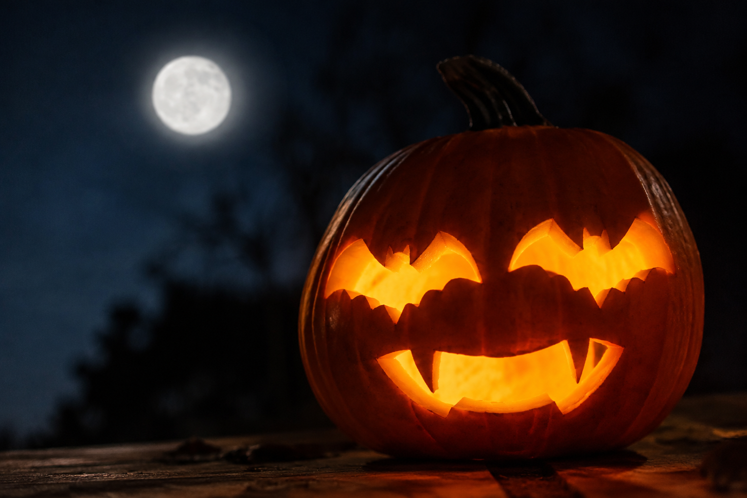 Jack-o-lantern with bat-wing shaped eye sockets and fanged mouth