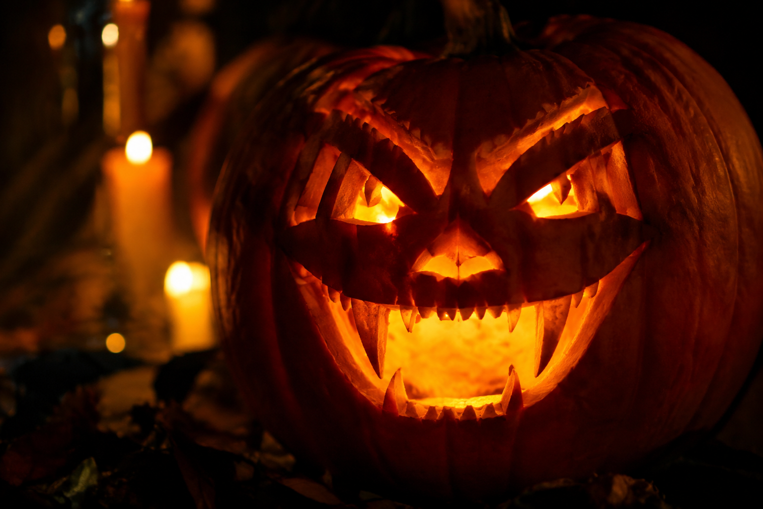 Vampire pumpkin face with sharp fanged teeth in gothic setting