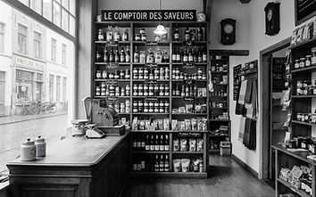 Black and white photo of the interior of a small independent shop