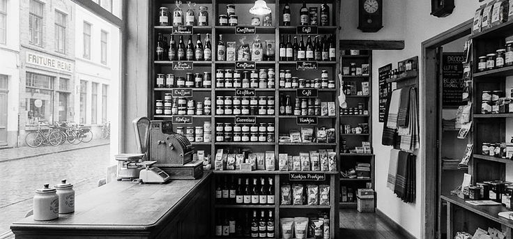 Black and white photo of the interior of a small independent shop