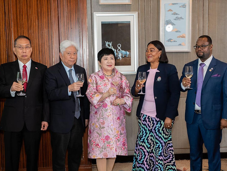 Five colleagues from FDM and a partner delegation raising wine glasses for a formal toast