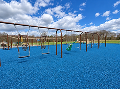 Row of swings including baby and adaptive swings at Keiper Park