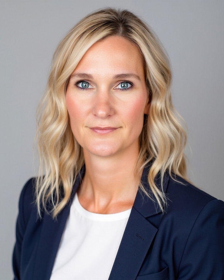 Dr. Amber Willmarth, wearing a navy blazer, photographed in professional portrait