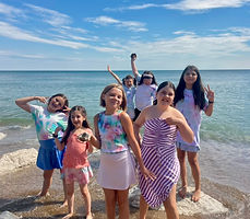 Showstoppers campers posing together at the beach