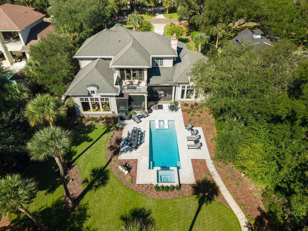 Aerial view of a finished backyard with pool, spa and shell stone deck in Colleton River