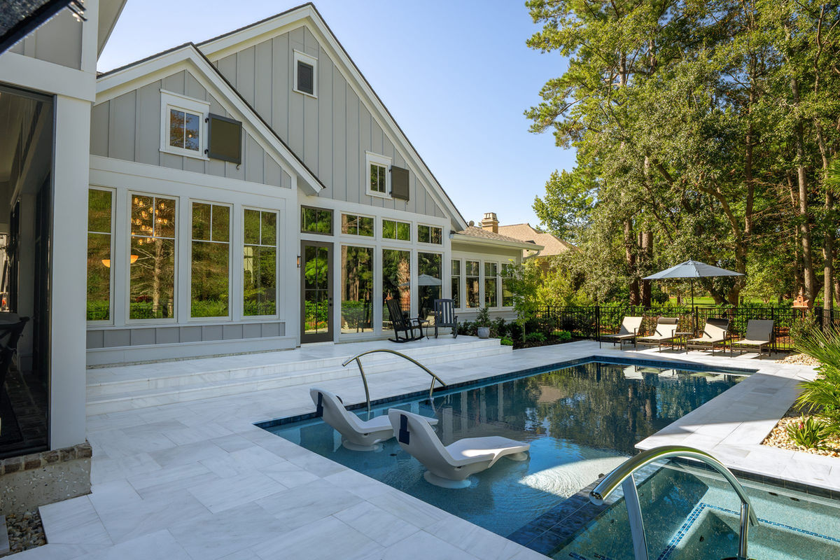 White marble pool deck and marble steps at a Berkeley Hall home in Bluffton