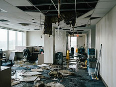 Water damaged commercial interior with soaked ceiling tiles after a burst fire sprinkler line in Dallas, TX - USPA Nationwide Security