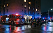 Detroit firefighters rescuing a resident from a west side apartment fire - emergency fire watch and building security response