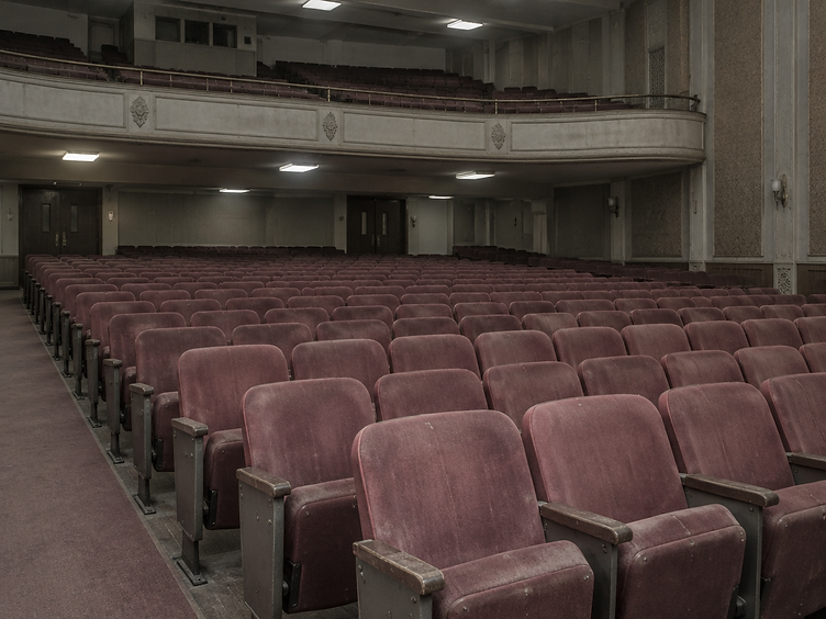 Worn and faded auditorium seating before refurbishment