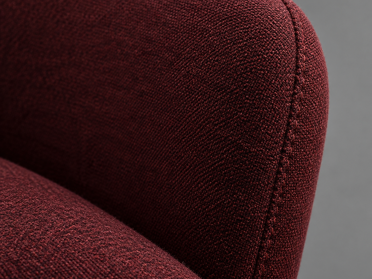 Burgundy wool upholstery being stretched over a high density foam seat back