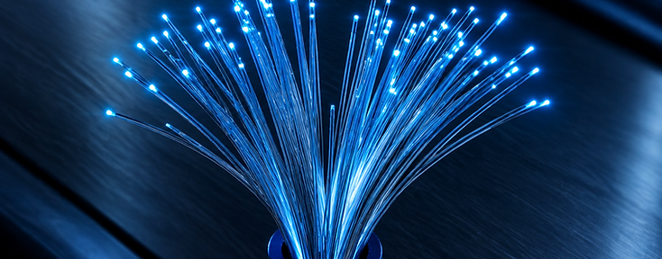 Macro photograph of fibre optic cables with glowing blue light