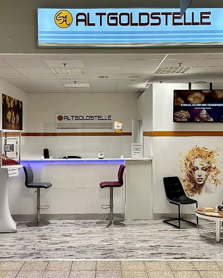 Die Altgoldstelle in der Globus Passage von vorn: Theke mit Barhockern, Vitrinen, Bildschirm und Warteecke unter dem beleuchteten Schild