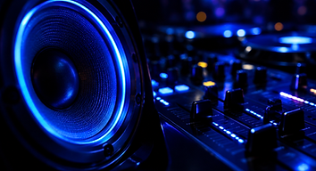 Gros plan d'une enceinte LED bleue et d'une table de mixage