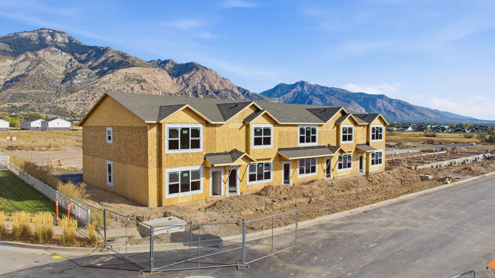 North Ogden Meadows · Angled view of townhome construction and the mountains