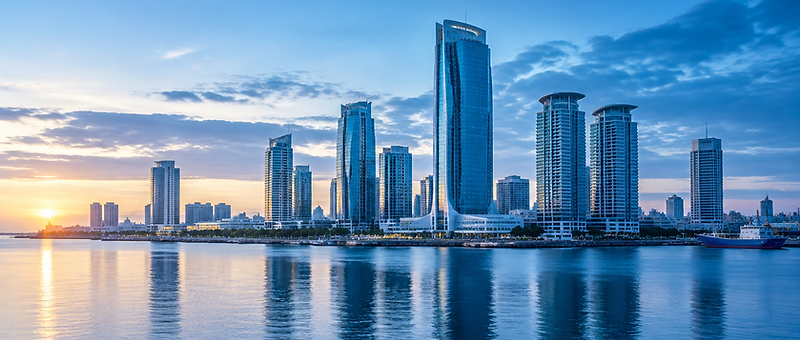 The Dar es Salaam central business district at dawn, with modern towers above the harbour