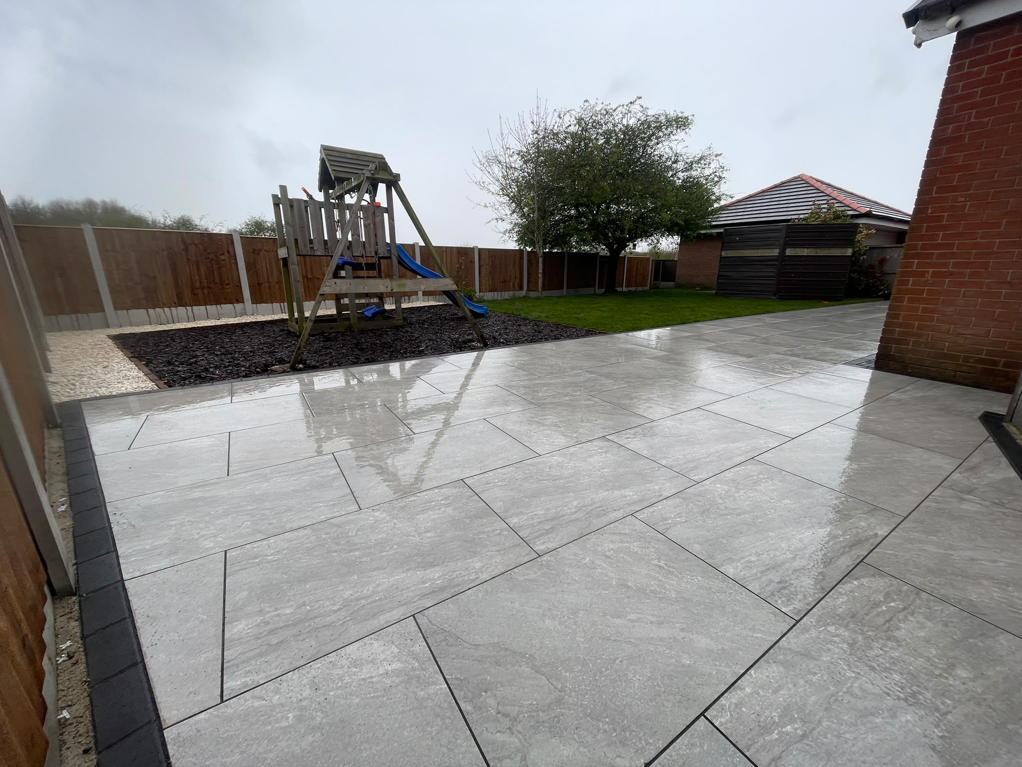 Grey porcelain patio with play area
