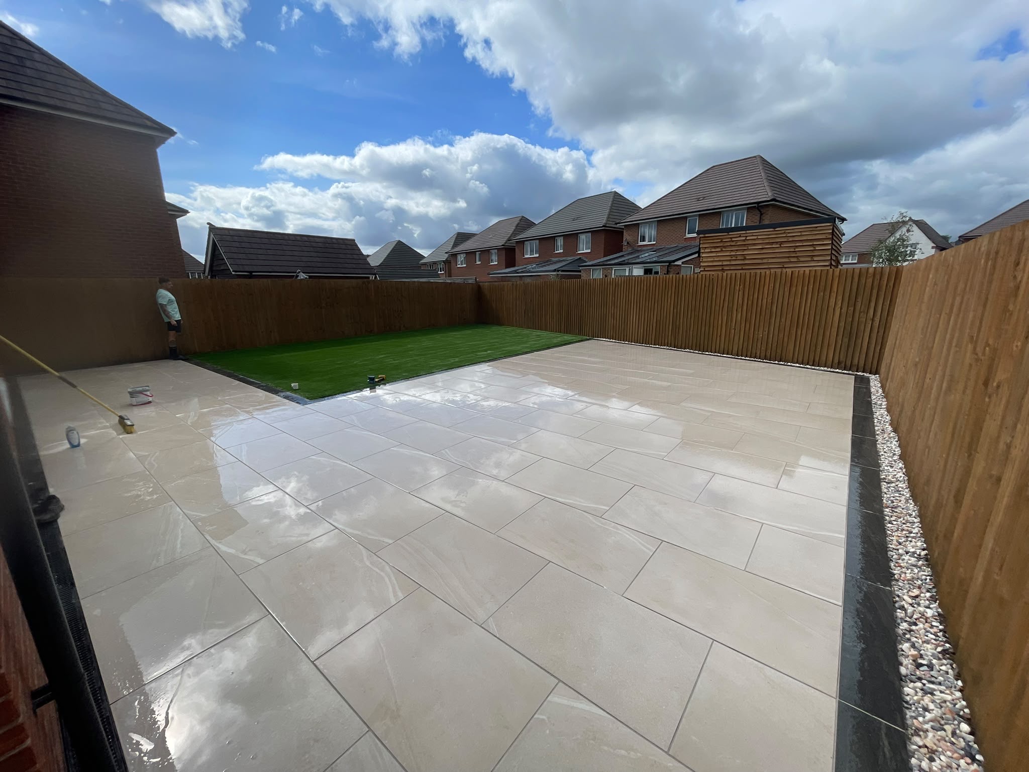 Beige porcelain patio with gravel drainage channel