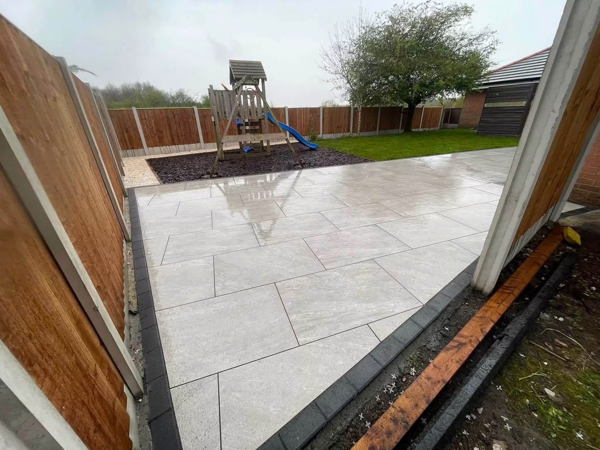 Porcelain patio with climbing frame and borders