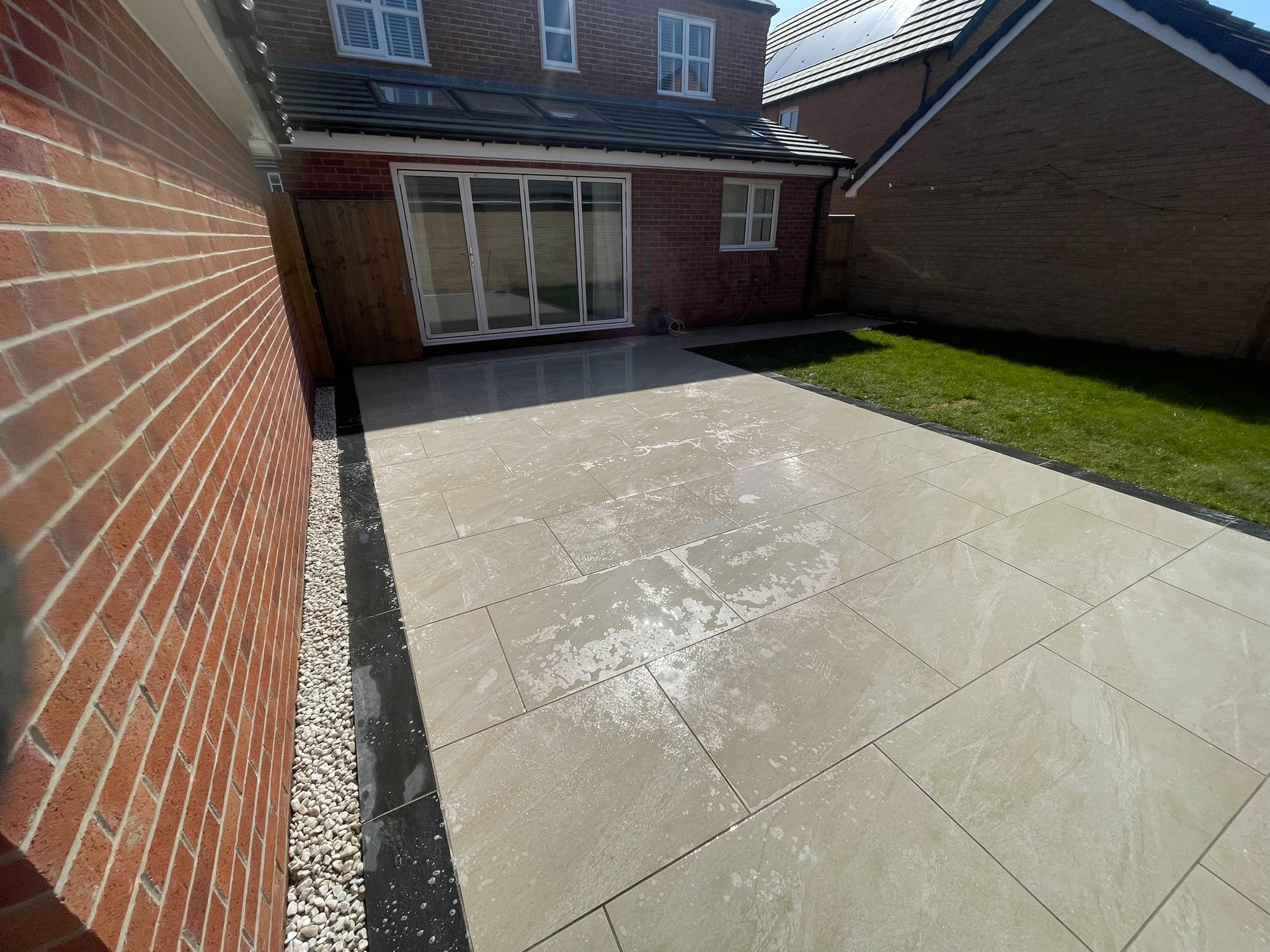 Porcelain patio with gravel border and bi-fold doors