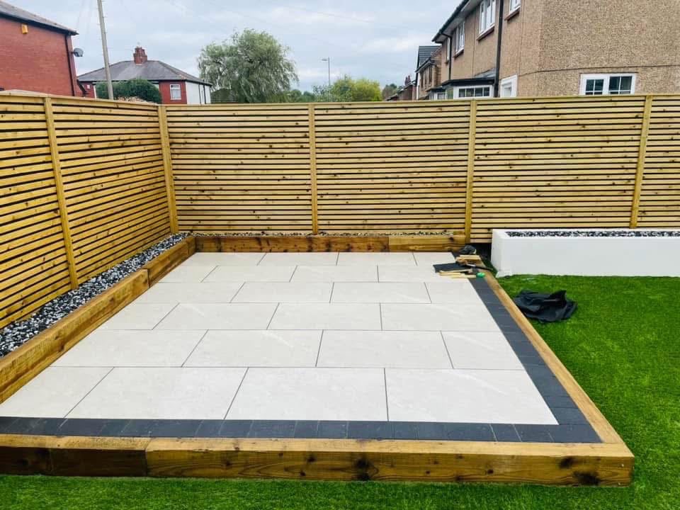 Patio with sleeper borders and rendered planter
