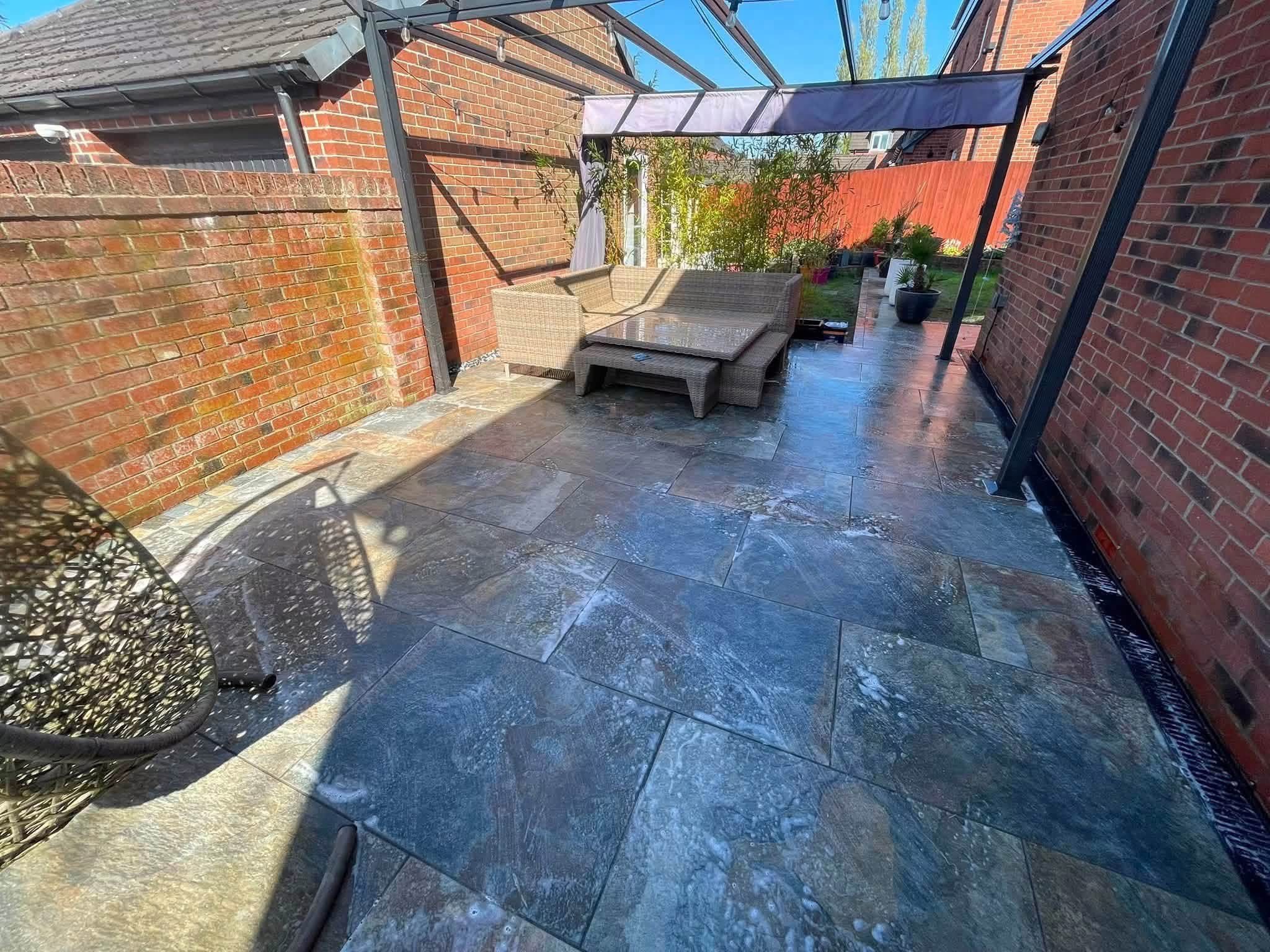 Slate patio with pergola seating area